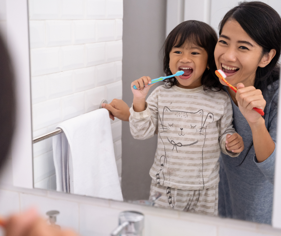 girl and mom brushing teeth