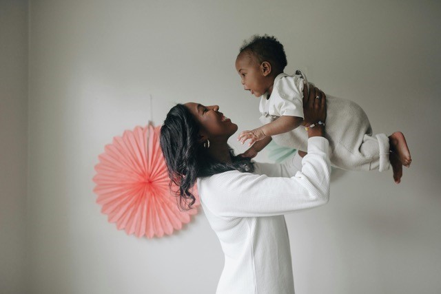 Lady Holding Baby in Air