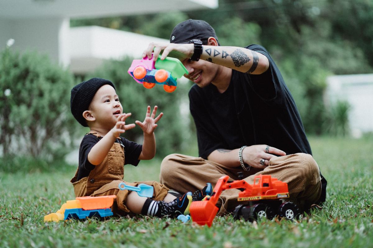 Man Playing With Child on Lawn