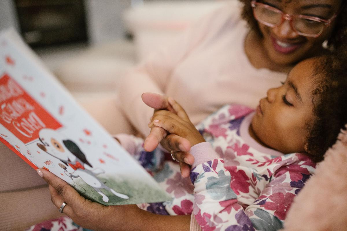 women reading to child